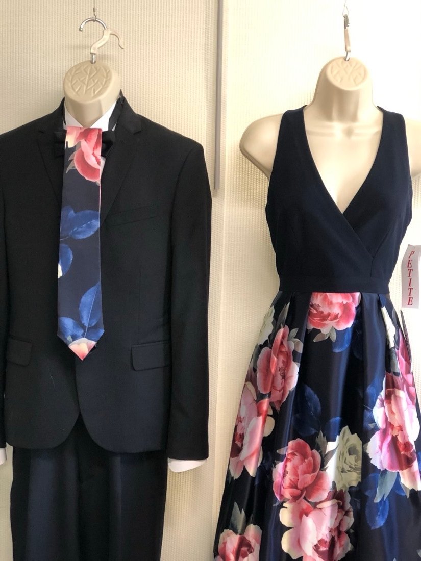 Custom-made necktie in a matching navy floral print, shown alongside the bridesmaid dress its fabric came from